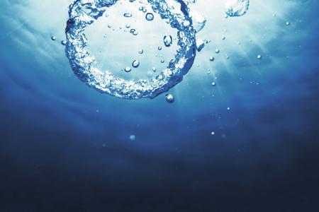 Bubble ring Underwater ascends towards the sun.の写真素材