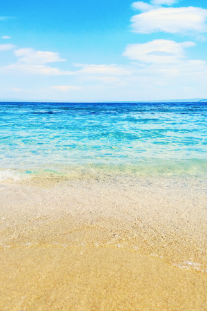 Wave of blue ocean on sandy beach Summer Backgroundの写真素材