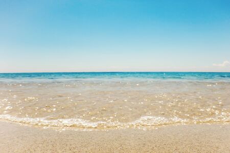 Wave of blue ocean on sandy beach Summer Backgroundの写真素材