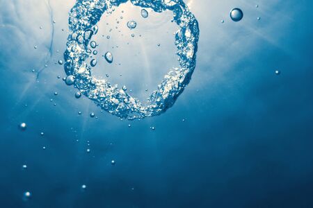 Bubble ring Underwater ascends towards the sun.の写真素材