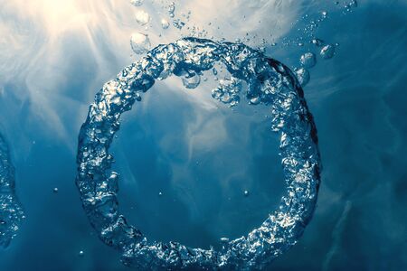 Bubble ring Underwater ascends towards the sun.の写真素材