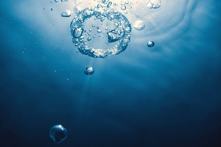 Bubble ring Underwater ascends towards the sun.の写真素材