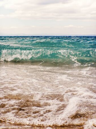 Wave of blue ocean on sandy beach Summer Backgroundの写真素材