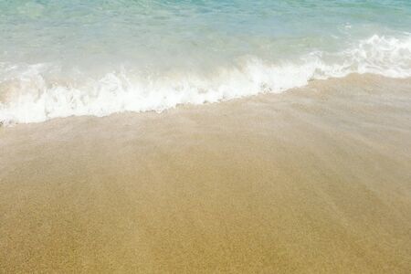 Wave of blue ocean on sandy beach close up Summer Backgroundの写真素材