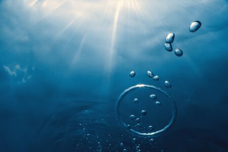 Bubble ring Underwater ascends towards the sun.の写真素材