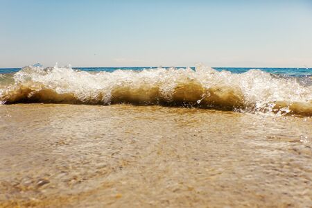 Wave of blue ocean on sandy beach Summer Backgroundの写真素材