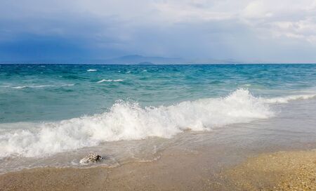 Strong waves crash over the beach Beautiful seascape.の写真素材