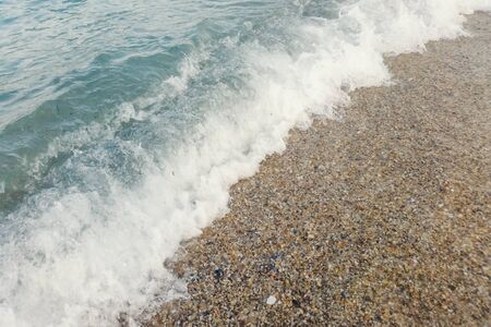 Wave of blue ocean on sandy beach close up Summer Backgroundの写真素材
