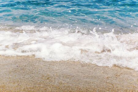 Wave of blue ocean on sandy beach Summer Backgroundの写真素材