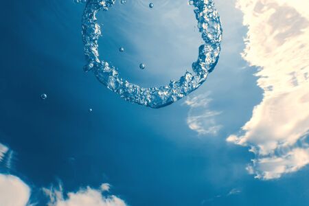 Bubble ring Underwater ascends towards the sun.の写真素材