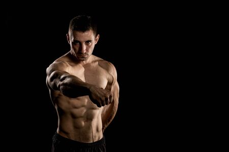 Bodybuilder Posing, Sporty Guy Male Power, Fitness Muscled Man, Spot Concept Copy Space, Dark Backgroundの写真素材