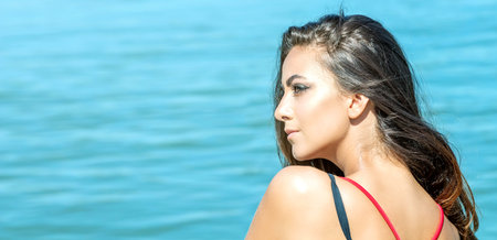 Portrait of beautiful woman on the sea Summer day background