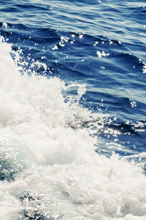 Ocean wave surface, crashing wave with foam on its topの写真素材