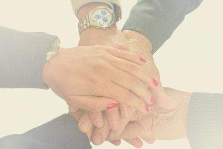 Business people putting their hands together. Arms consolidation, Teamwork concept.