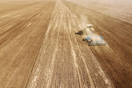 Aerial view Tractor preparing field, Agriculture tractor landscapeの写真素材