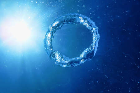 Bubble Ring Ascends towards the Sun, Underwaterの写真素材