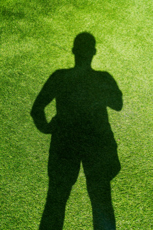 Shadow of a man on the grass, artificial grass