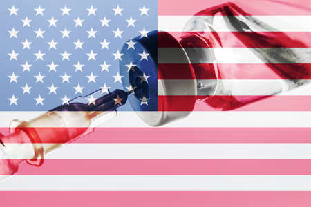 USA Vaccination, Coronavirus, Covid-19,Sars-Cov-2, USA flag, Vaccine vial dose, needle syringe, concept vaccination, disease care, prevention immunizationの写真素材
