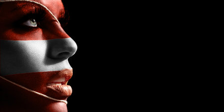 Austria flag painted on a face of a young woman, national flag on faceの写真素材