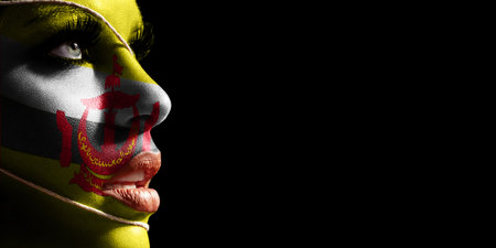Brunei flag painted on a face of a young woman, national flag on faceの写真素材
