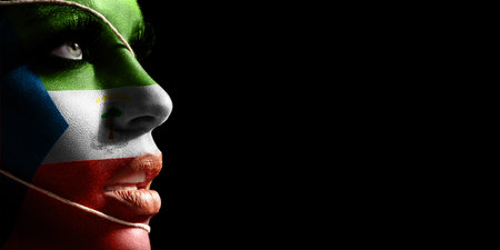 Equatorial Guinea flag painted on a face of a young woman, national flag on faceの写真素材