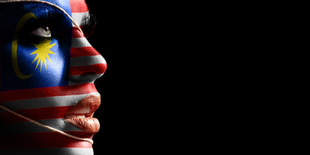 Malaysia flag painted on a face of a young woman, national flag on faceの写真素材