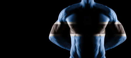 Botswana flag on muscled male torso with abs, black backgroundの写真素材