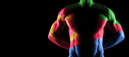 Eritrea flag on muscled male torso with abs, black backgroundの写真素材