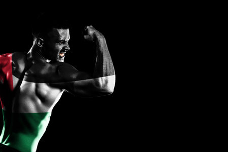 Jordan flag on handsome young muscular man black backgroundの写真素材