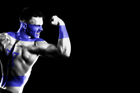 Israel flag on handsome young muscular man black backgroundの写真素材