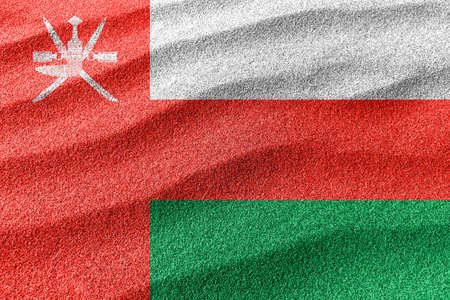 Oman sand flag, national flag sand backgroundの写真素材