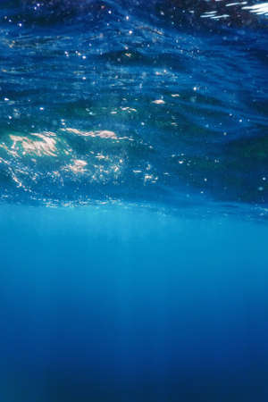 Underwater view of the blue sea surfaceの写真素材
