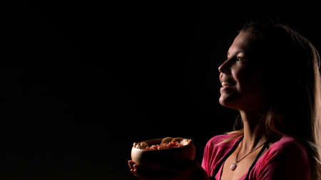 Female holding raw vegan healthy food. Raw food concept  bamboo bowlの写真素材