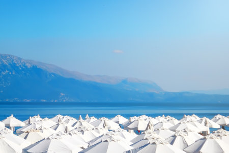 Overcrowded beach, white umbrellas against the sea, Summer timeの写真素材