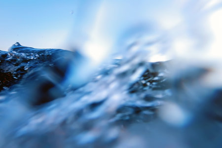 Sea wave splash close up, low angle view water background