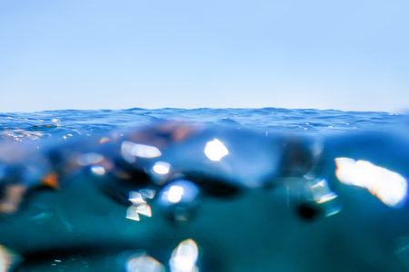 Sea wave splash close up, low angle view water background