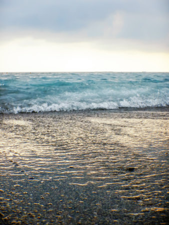 Breaking Wave of Blue Ocean on Pebbles beach Summer Backgroundの写真素材