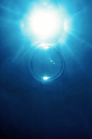 Bubble Ring Underwater Ascends Towards The Sunの写真素材