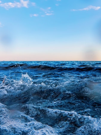 Sea wave splash close up, low angle view water background