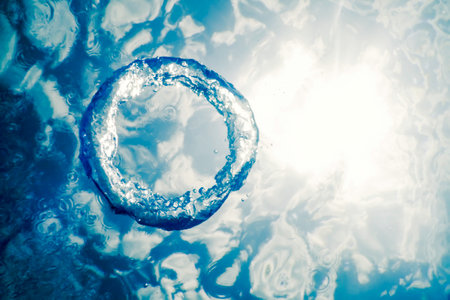 Bubble Ring Underwater Ascends Towards The Sunの写真素材