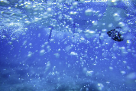 Stand up Paddle Board Underwater View with Bubbles in the Seaの写真素材