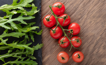 organic food is arugula and cherry tomatoesの写真素材