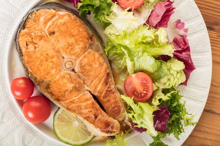 cooked steak salmon with vegetables top viewの写真素材