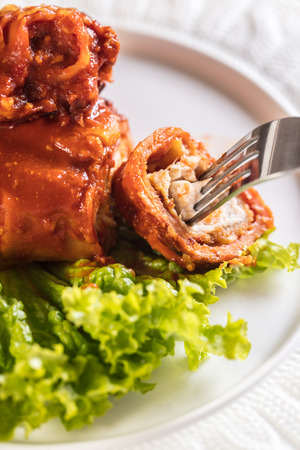 chicken baked in pastry with cheese and tomato sauceの写真素材