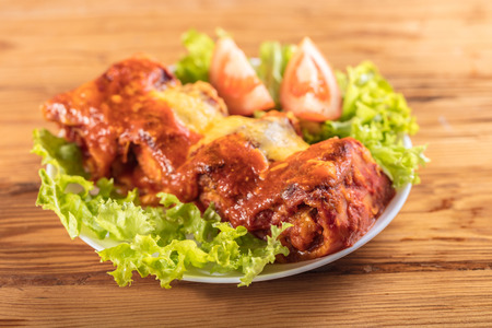 chicken baked in pastry with cheese on a wooden backgroundの写真素材