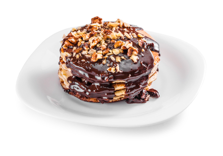 Pancake with chocolate and walnuts on a white backgroundの写真素材