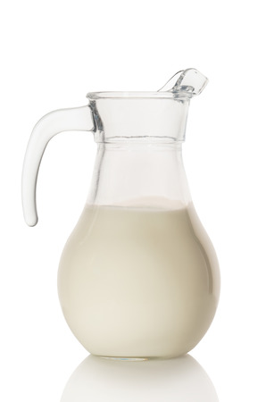 milk in the carafe on white backgroundの写真素材