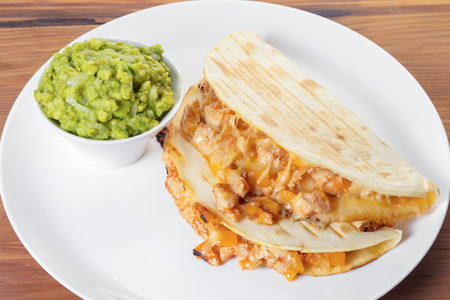 Quesadilla with guacamole sauce on a wooden backgroundの写真素材