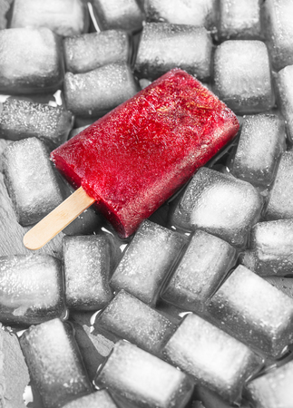 Frozen juice on stick closeup background of iceの写真素材