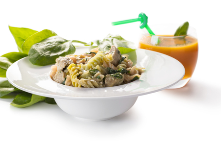 Italian cuisine, color pasta with spinach and carrot juiceの写真素材